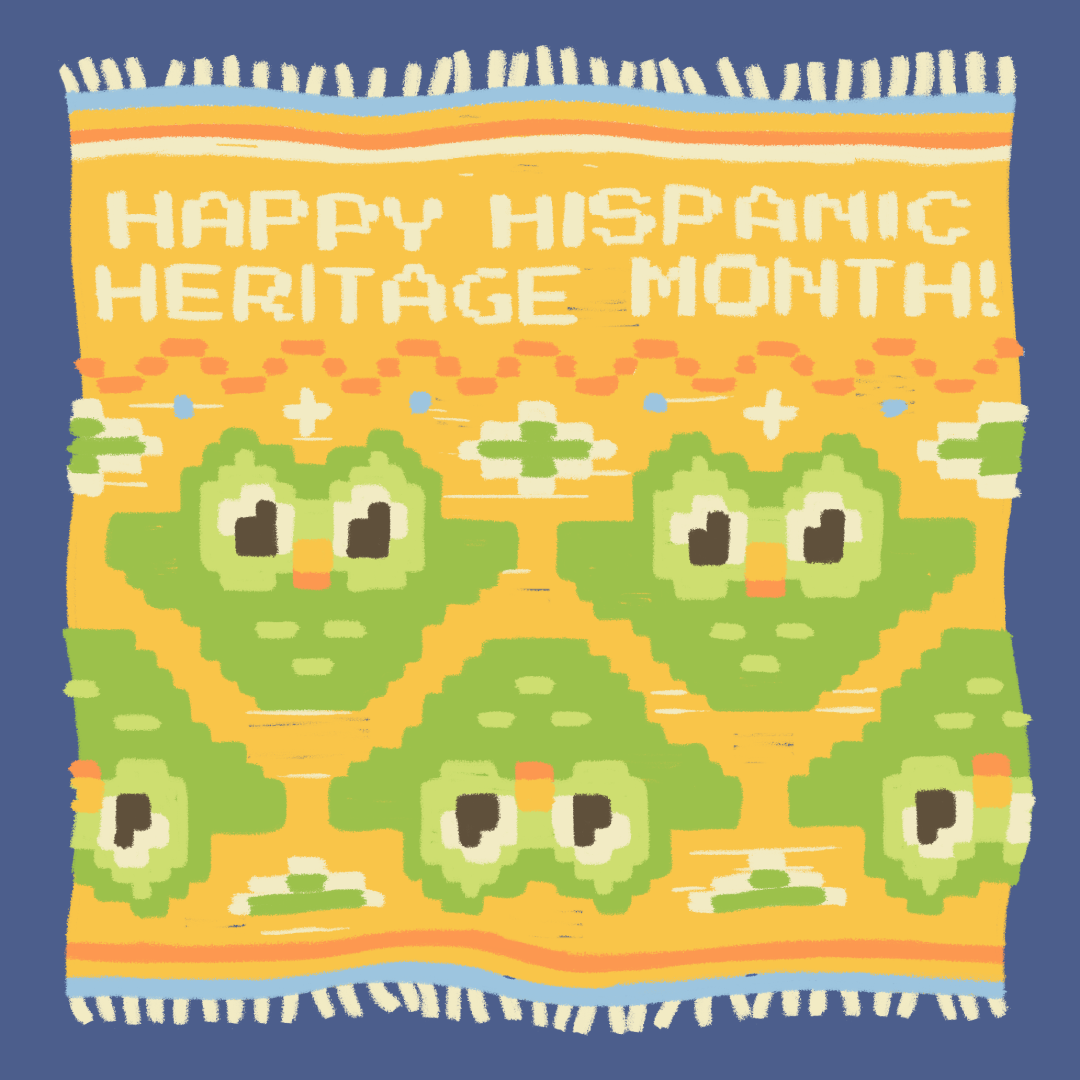 Ilustración de una cobija bordada a mano similar al estilo tradicional de México y Centro América con las palabras en inglés: "Happy Hispanic Heritage Month" y bordados del búho de Duolingo como parte del diseño