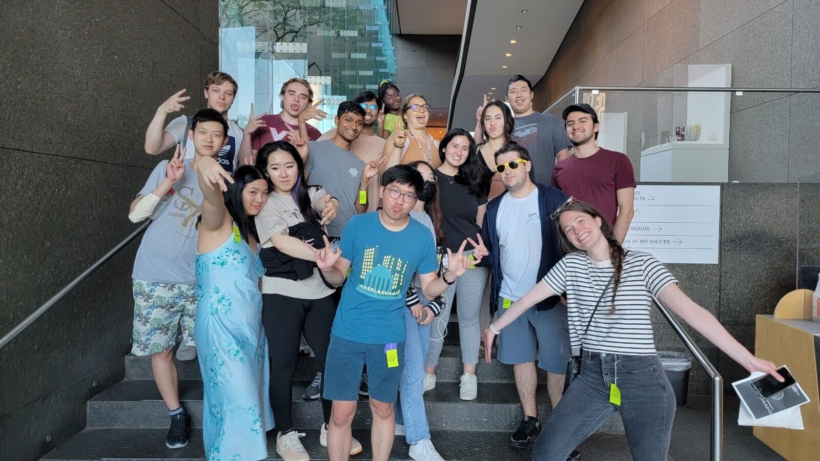 A group of interns smiling on the steps of a Pittsburgh museum