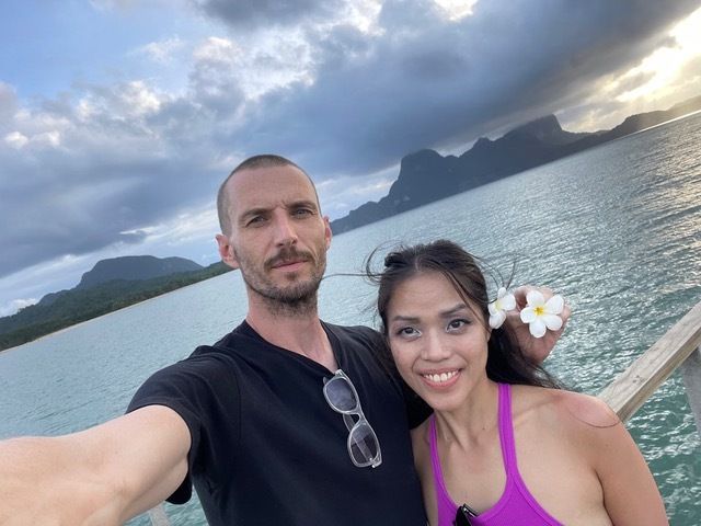 Rob and Amanda taking a selfie in front of the ocean