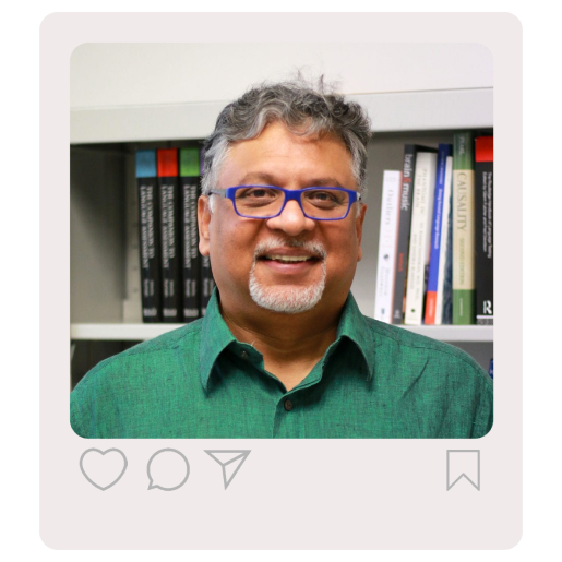 A headshot of Antony. He is standing in front of a bookshelf and smiling at the camera. An Instagram-esque frame surrounds the photo.