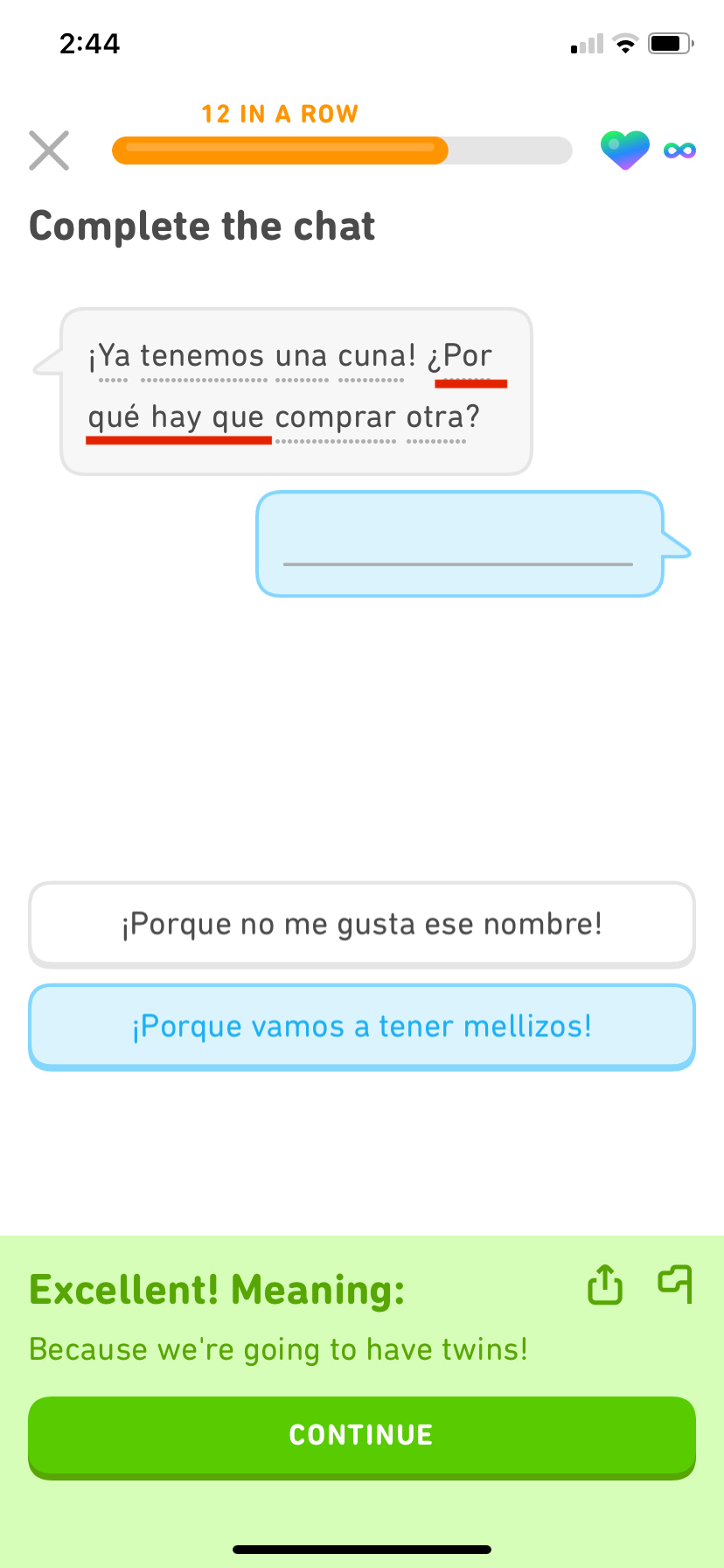 Screenshot of a Duolingo dialogue exercise. The first speech bubble says something in Spanish, and it has a red underline for "por qué hay que," which is discussed in the blog post. The second speech bubble is empty and the learner has correctly selected an answer meaning "Because we're going to have twins!"