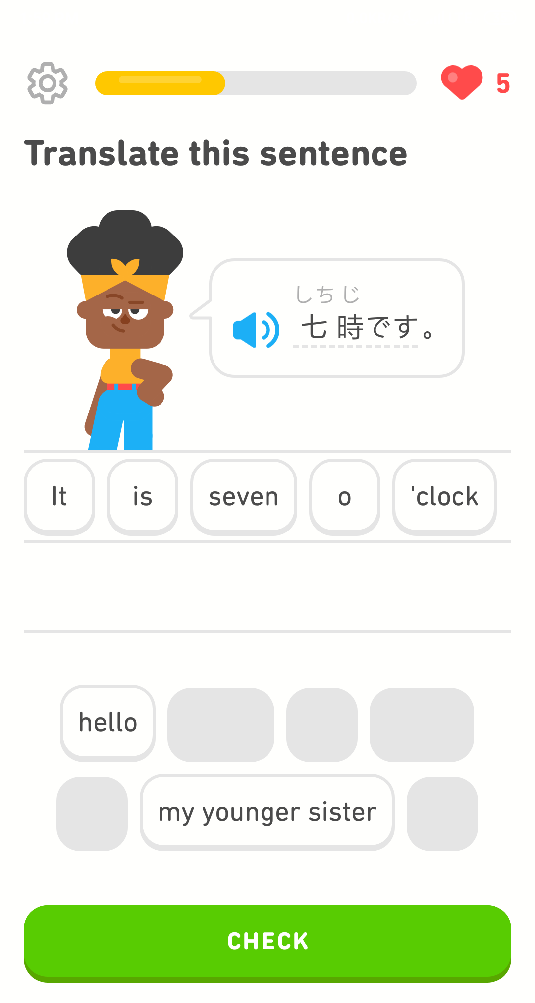 Screenshot of an exercise with Bea standing next to a sentence written partly in kanji with smaller, gray hiragana characters above the sentence. The tiles for the answer translation read "It is seven o'clock."