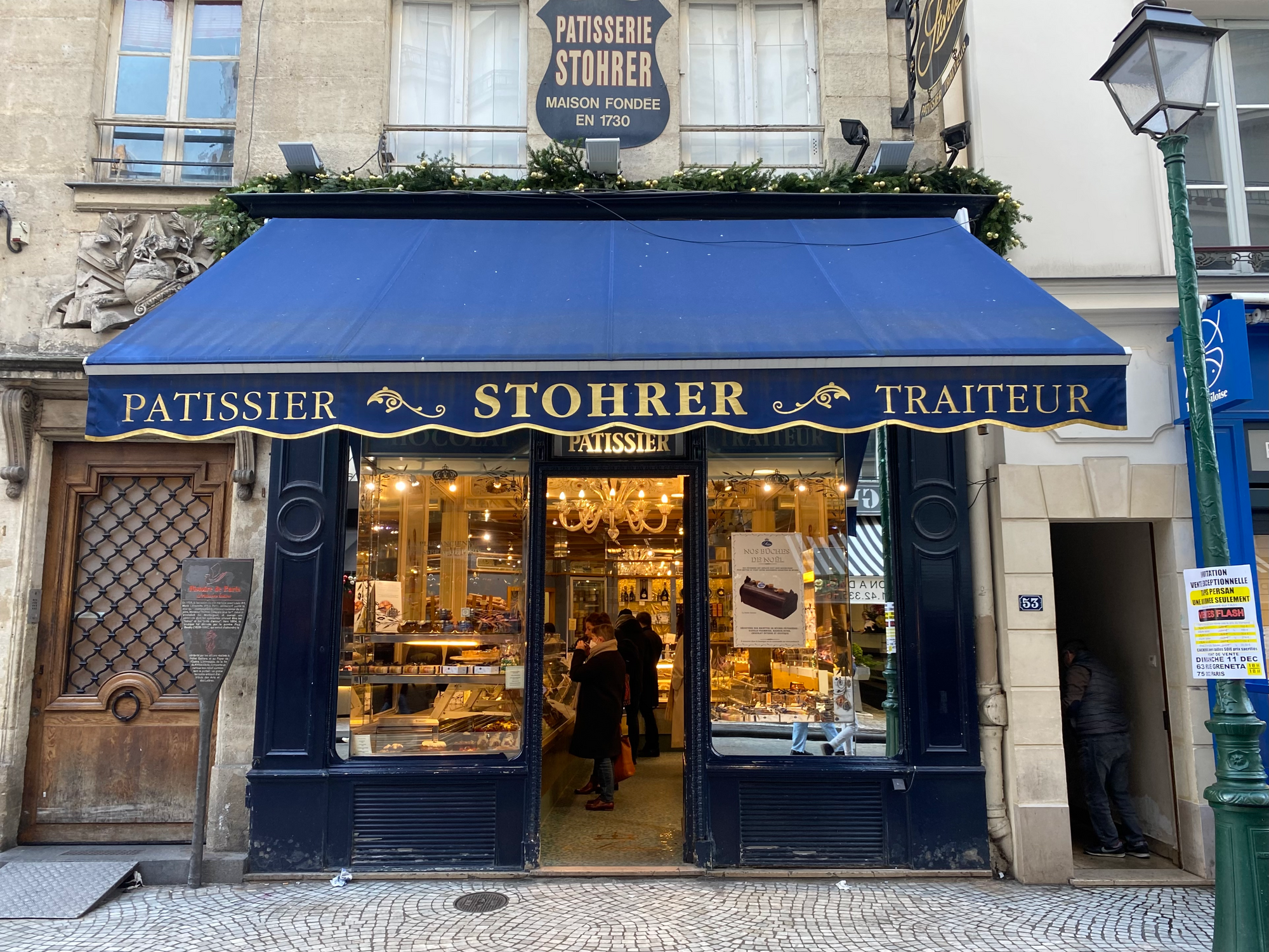 The Stohrer storefront is a dark blue awning with gold lettering that says “Stohrer” in the center. Photo Credit: Justine Hagard