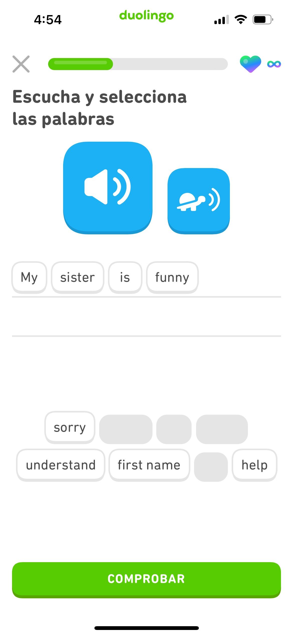 screenshot of an exercise in the English course for Spanish speakers. There is a microphone button, which plays a sentence in English, and the learner has used word tiles to write the sentence: 'My sister is funny.'