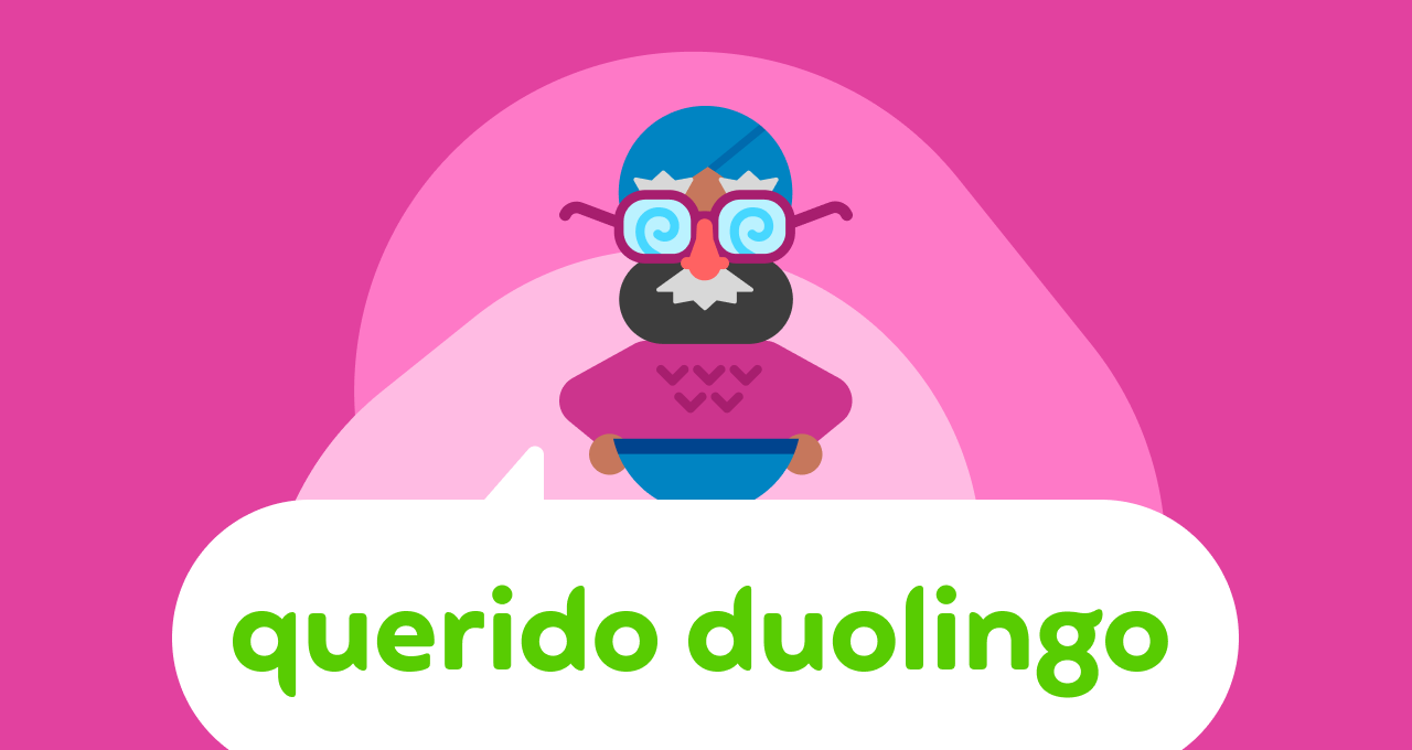 Ilustração do logotipo do Querido Duolingo. O Vikram aparece acima do balão onde está escrito “Querido Duolingo”, e ele usa um disfarce com óculos, sobrancelhas, nariz e bigode.
