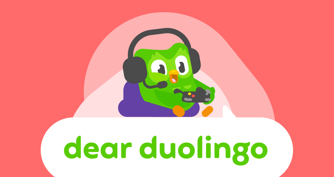 Dear Duolingo logo with Duo the owl sitting on a cushion holding a game controller and wearing headphones with a microphone attached.