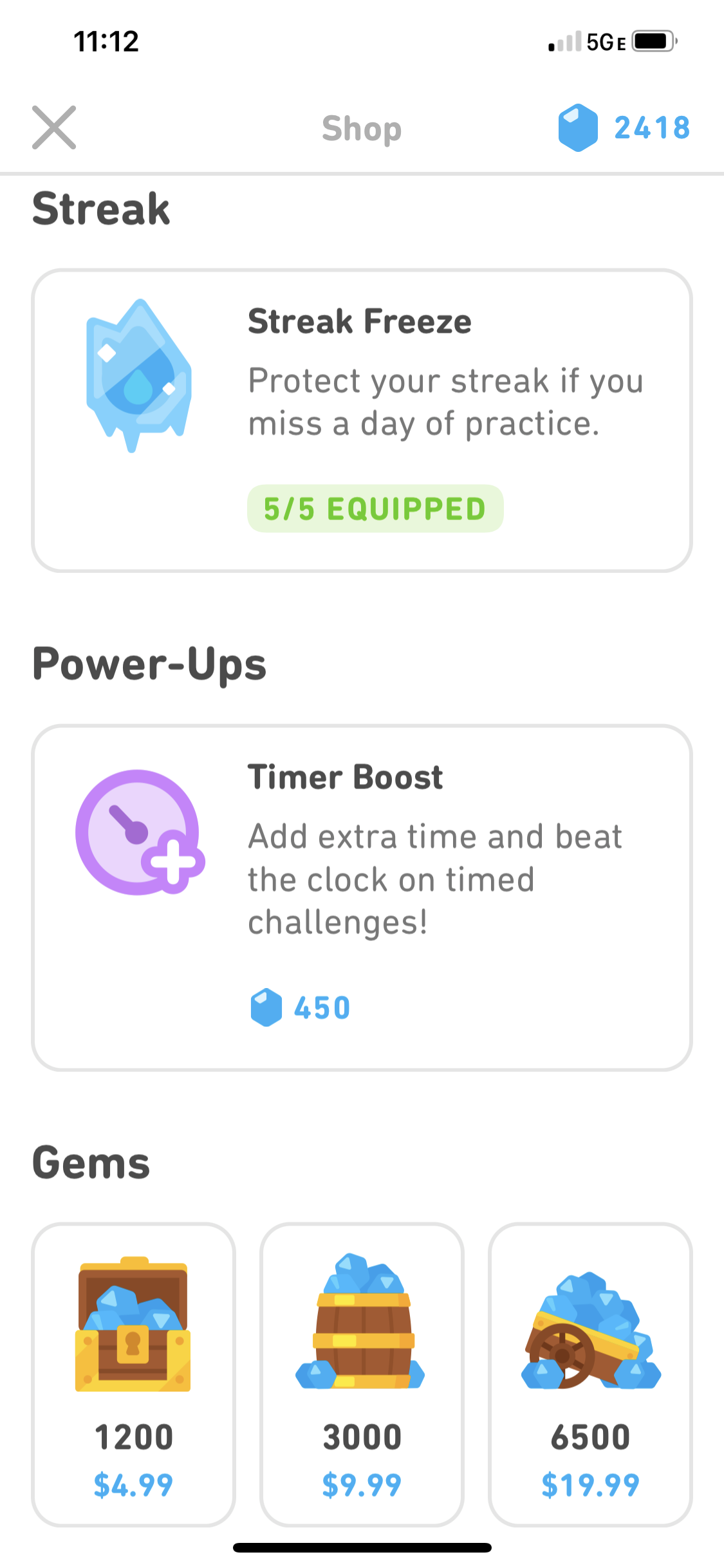 Screenshot of the Shop in the Duolingo app. At the top is the Streak Freeze section, showing that this user has 5 of 5 Streak Freezes equipped. In the middle is the Power-Ups section, where you can buy a Timer Boost for 450 gems. At the bottom is where you can buy 1200, 3000, or 6500 gems.