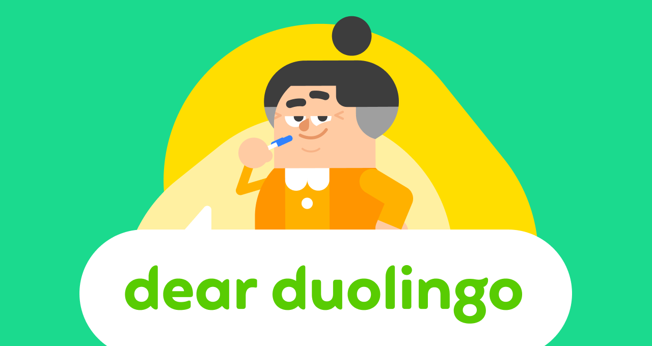 Duolingo character Lucy holding a pen to her chin looking thoughtful.