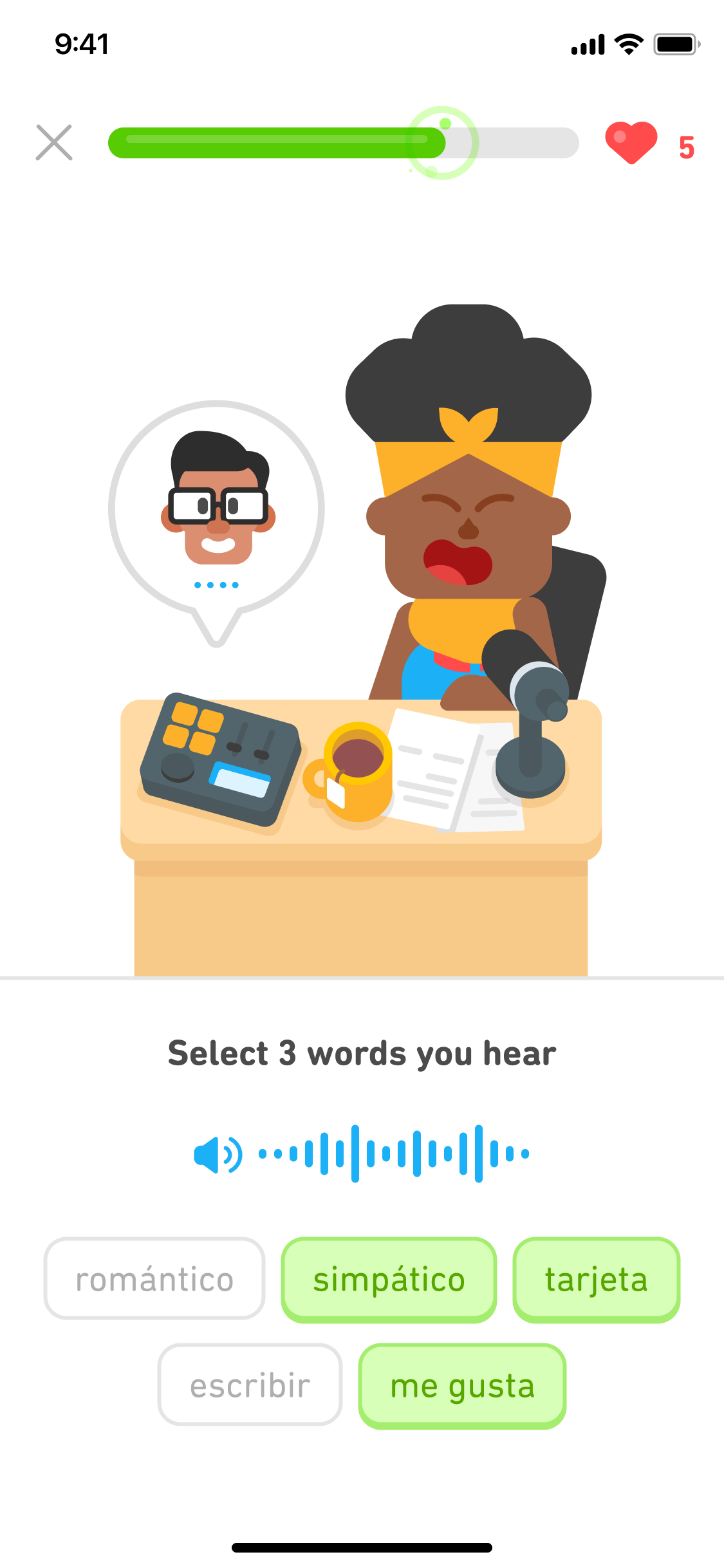 Screenshot of an exercise in the middle of a DuoRadio lesson, with an illustration of Bea sitting at a desk in front of a microphone. The instructions say 'Select 3 words that you hear' followed by a blue speaker button and audio wave and a list of 5 Spanish word tiles to choose from.
