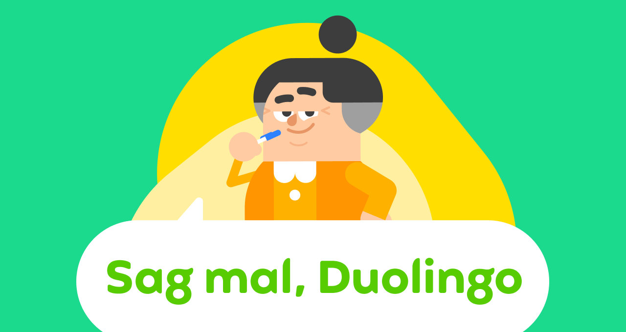 Duolingo-Charakter Lucy hält einen Stift an ihr Kinn. Sie sieht dabei nachdenklich aus und lächelt.