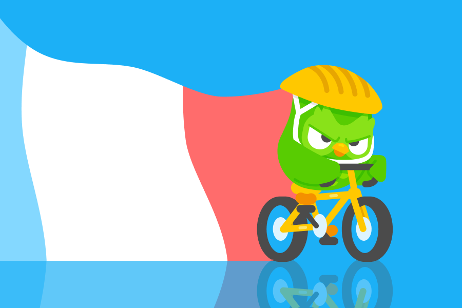 Abbildung von Duo vor der französischen Flagge. Er fährt ein gelbes Fahrrad, trägt einen Helm und sieht entschlossen aus.