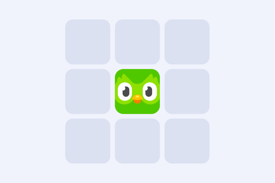 Illustration of a 3 by 3 grid of gray blocks with the green Duolingo app icon at the center