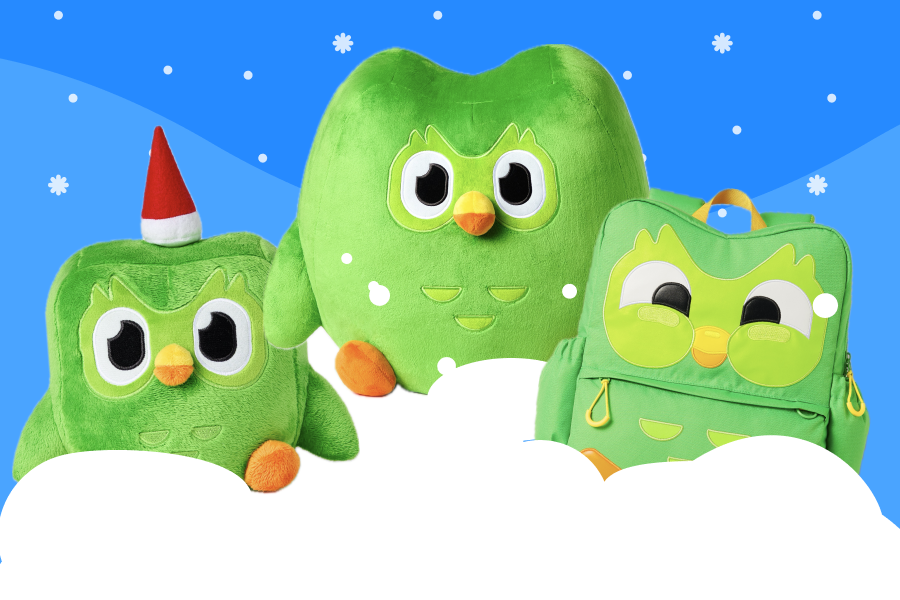 2 Duo plushies and a Duo-shaped backpack sitting on a pile of snow.